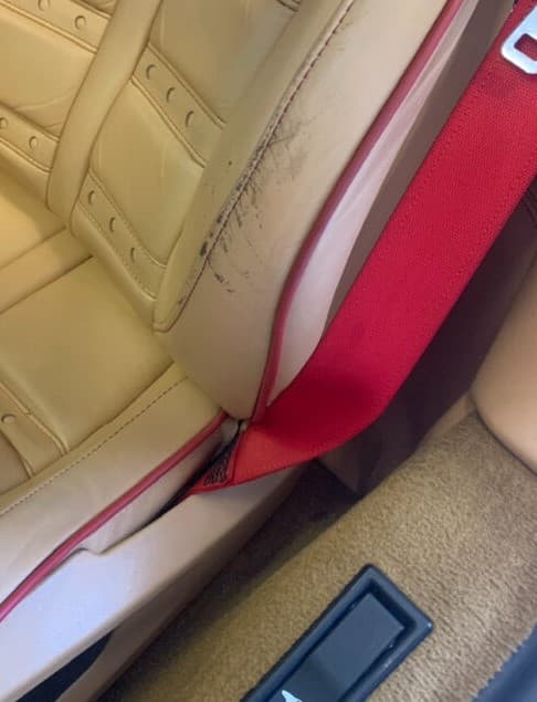 Classic car leather seat before repair — split seam along side bolster area