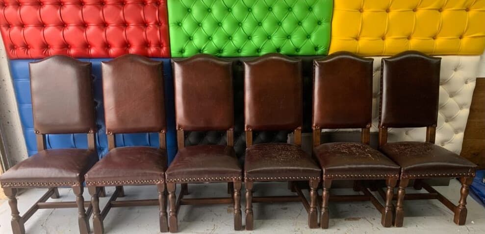 Hotel leather chairs before professional commercial upholstery restoration — worn and damaged seating