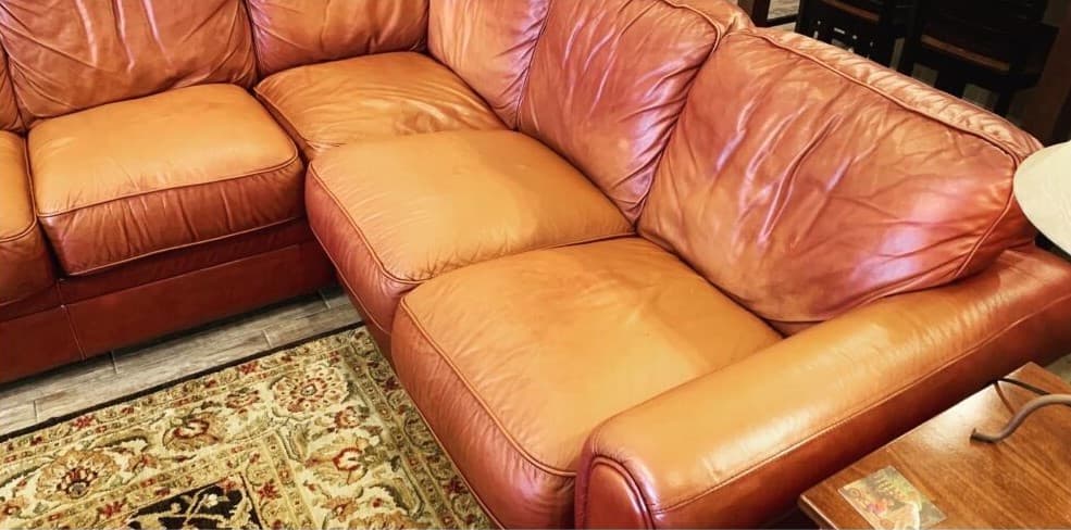 Faded orange leather sectional before color restoration in Bucks County PA
