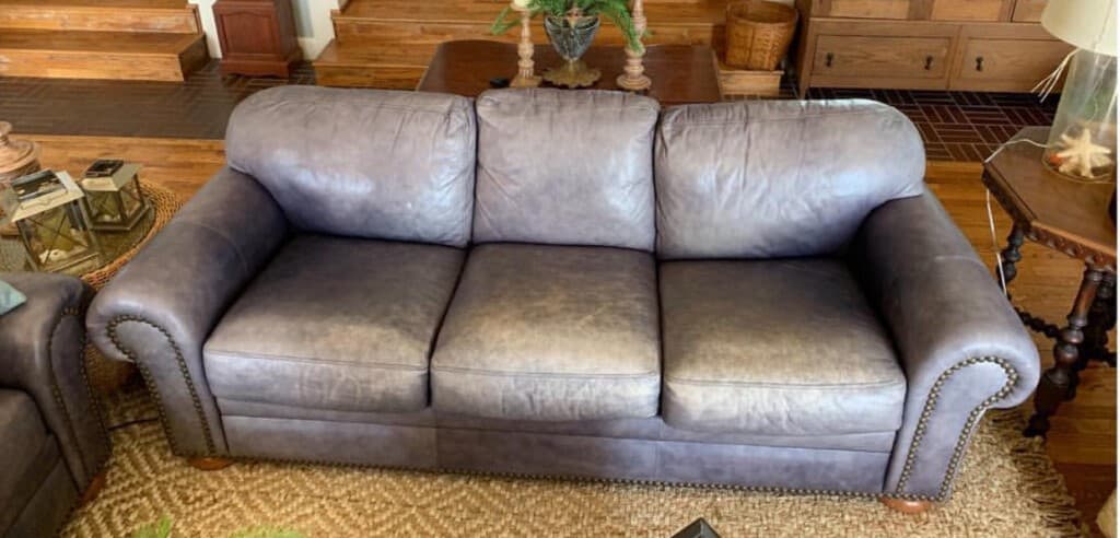 Faded blue-gray nailhead sofa before restoration in Cherry Hill NJ
