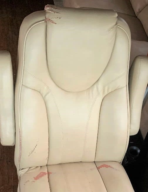 RV captain chair before restoration — torn headrest and damaged upholstery