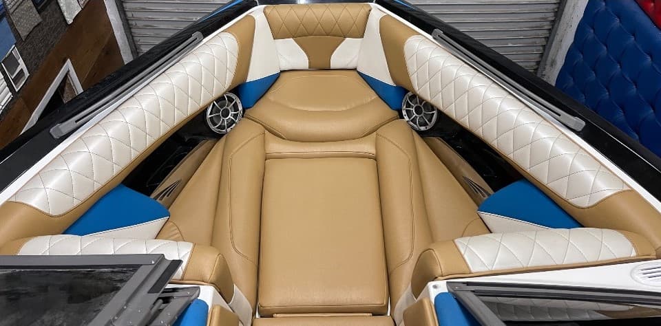Performance boat after custom diamond stitch marine upholstery in tan, cream, and blue